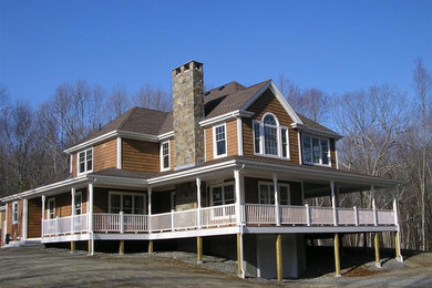 Inspiration for a timeless brown exterior home remodel in Bridgeport with a hip roof