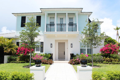 Large beach style multicolored two-story mixed siding exterior home photo in Miami with a metal roof