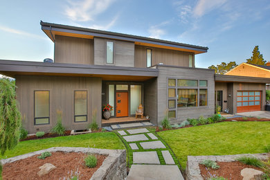 Trendy brown two-story wood flat roof photo in Portland