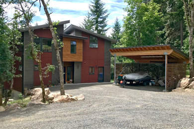 Mid-sized contemporary red two-story mixed siding house exterior idea in Portland with a shed roof and a metal roof