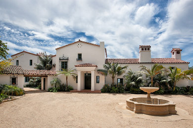 Inspiration for a huge mediterranean white two-story stucco gable roof remodel in Santa Barbara