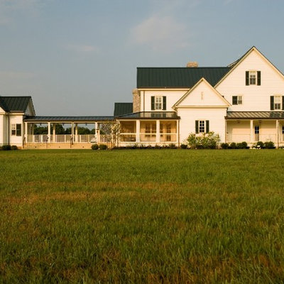 Example of a farmhouse wood gable roof design in Nashville