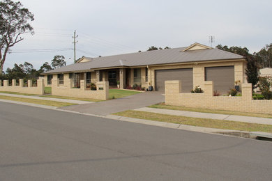 This is an example of a contemporary house exterior in Newcastle - Maitland.
