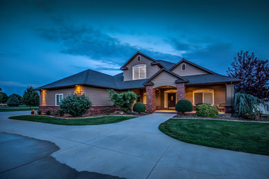 Large elegant brown two-story wood exterior home photo in Boise with a hip roof