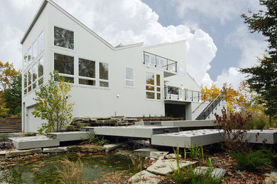 Trendy white two-story exterior home photo in Detroit