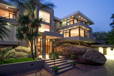 Example of a trendy two-story exterior home design in Other