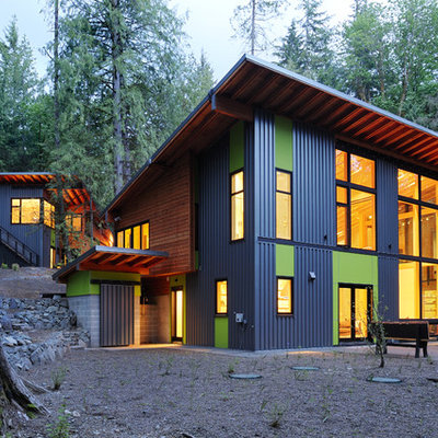 Large trendy multicolored two-story mixed siding house exterior photo in Seattle with a shed roof