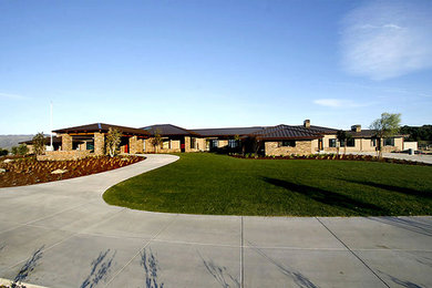 Expansive and beige contemporary bungalow house exterior in San Luis Obispo with mixed cladding.