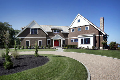 Idée de décoration pour une façade de maison marron tradition en bois à un étage avec un toit à deux pans.