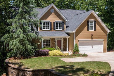 Example of a huge arts and crafts yellow three-story vinyl exterior home design in Atlanta