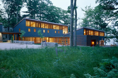 Inspiration for a large modern gray two-story wood exterior home remodel in Portland Maine with a shed roof