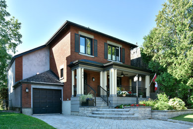 Inspiration for a mid-sized transitional brown two-story brick exterior home remodel in Ottawa with a hip roof