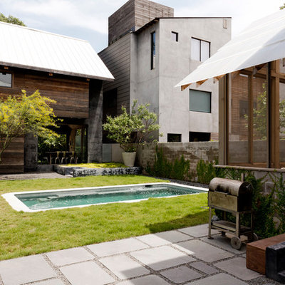 Mid-sized contemporary brown three-story mixed siding exterior home idea in Houston with a shed roof
