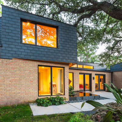Example of a large trendy red two-story mixed siding exterior home design in Houston