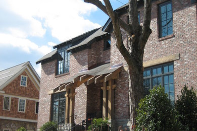 Large elegant two-story brick house exterior photo in Atlanta with a hip roof and a shingle roof