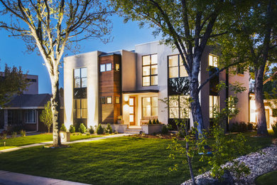 Inspiration for a mid-sized contemporary beige two-story stucco exterior home remodel in Denver
