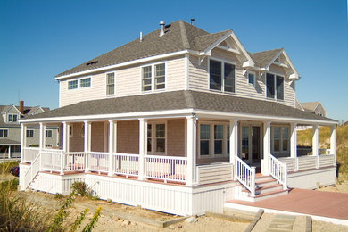 Inspiration for a large coastal beige two-story wood gable roof remodel in Boston