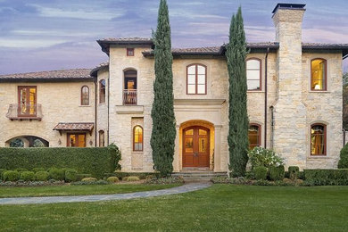 Photo of a beige contemporary two floor house exterior in Dallas with stone cladding.