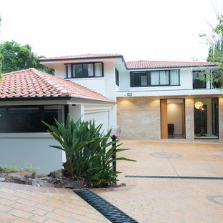 Photo of a contemporary two-storey white house exterior in Sydney with mixed siding, a hip roof and a tile roof.
