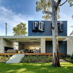 Inspiration for a contemporary two-storey black house exterior in Sydney with mixed siding and a flat roof.