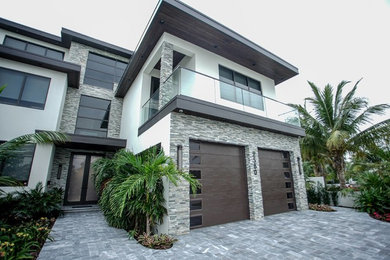 Inspiration for a large contemporary multicolored two-story mixed siding house exterior remodel in Orlando