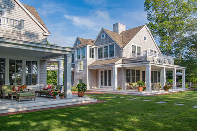 Inspiration for a large timeless beige two-story wood gable roof remodel in Boston