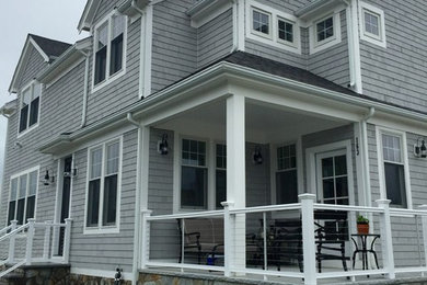 Inspiration for a large coastal gray two-story mixed siding house exterior remodel in Boston with a hip roof and a shingle roof