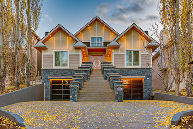 Inspiration for an expansive and beige traditional two floor detached house in Calgary with concrete fibreboard cladding.