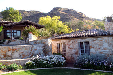 Example of a classic one-story stone exterior home design in Phoenix