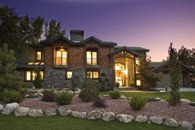Mid-sized mountain style brown two-story stone exterior home photo in Salt Lake City with a shingle roof