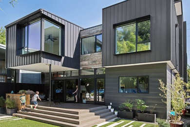Inspiration for a modern black three-story metal flat roof remodel in Portland