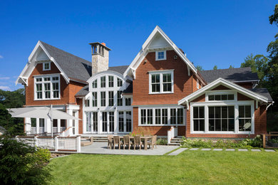 Inspiration for a large timeless brown two-story wood exterior home remodel in Boston with a shingle roof