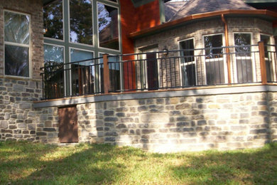 Foto de fachada gris clásica de dos plantas con revestimiento de piedra