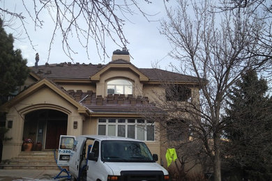 Inspiration for a huge rustic three-story exterior home remodel in Denver with a hip roof
