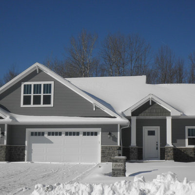 Mid-sized elegant gray split-level vinyl exterior home photo in Other