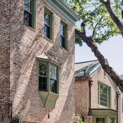 Large traditional three-story brick exterior home idea in DC Metro