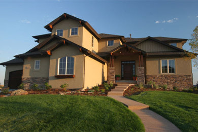 Inspiration for a mid-sized beige two-story stucco exterior home remodel in Denver