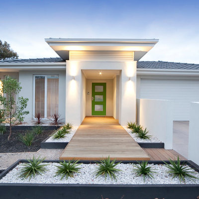 Small 1960s white one-story exterior home idea in Other with a hip roof