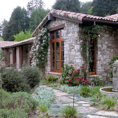 Example of a classic stone exterior home design in Other