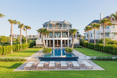 Coastal brown three-story mixed siding house exterior idea in Charleston with a hip roof and a metal roof