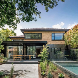 Asian two-storey brown house exterior in Melbourne with mixed siding, a hip roof and a tile roof.