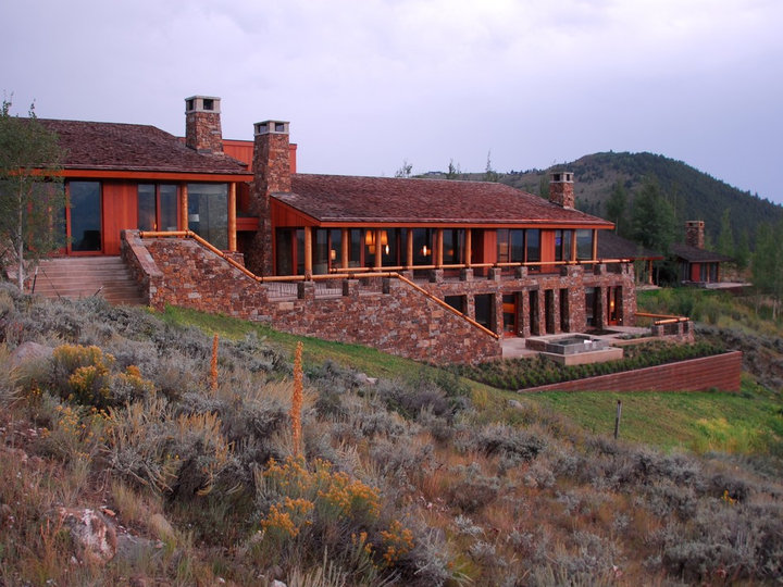 Idea for a large, two-story gable roof in a rustic brown siding.