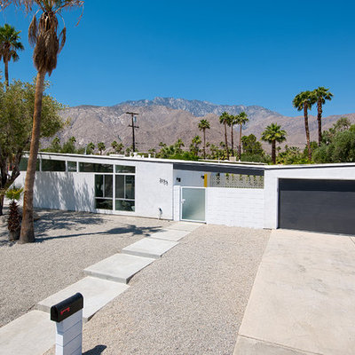 1950s one-story exterior home idea in Other with a butterfly roof