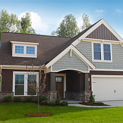 Mid-sized craftsman blue two-story mixed siding exterior home idea in Other with a shingle roof