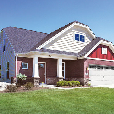 Example of a mid-sized arts and crafts red two-story mixed siding exterior home design in Other