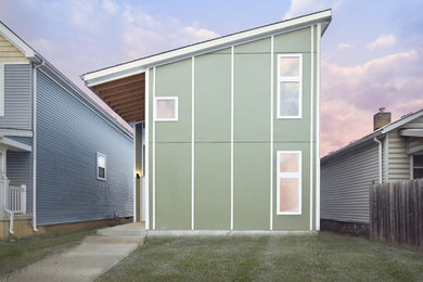 Modelo de fachada gris minimalista de tamaño medio de dos plantas con revestimiento de aglomerado de cemento y tejado de un solo tendido