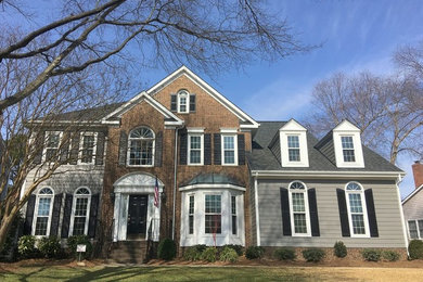Inspiration for a mid-sized timeless gray two-story concrete fiberboard exterior home remodel in Charlotte with a shingle roof