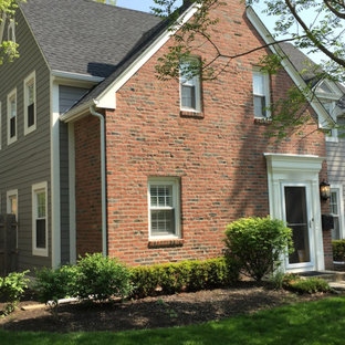 Example of a mid-sized classic gray two-story concrete fiberboard exterior home design in Columbus