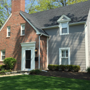 Example of a classic gray two-story concrete fiberboard exterior home design in Columbus