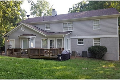 Example of a mid-sized classic gray two-story mixed siding exterior home design in Charlotte with a shingle roof